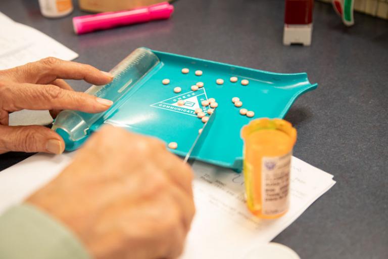 Pills being organized into bottle