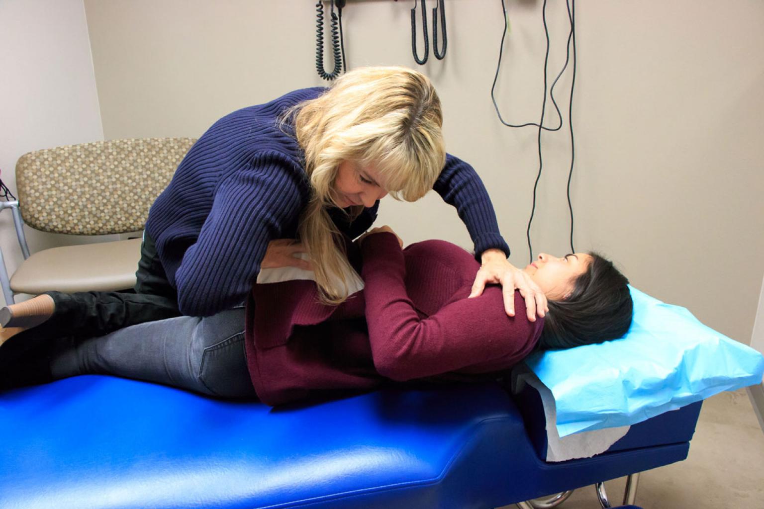 Chiropractor with patient twisting their body