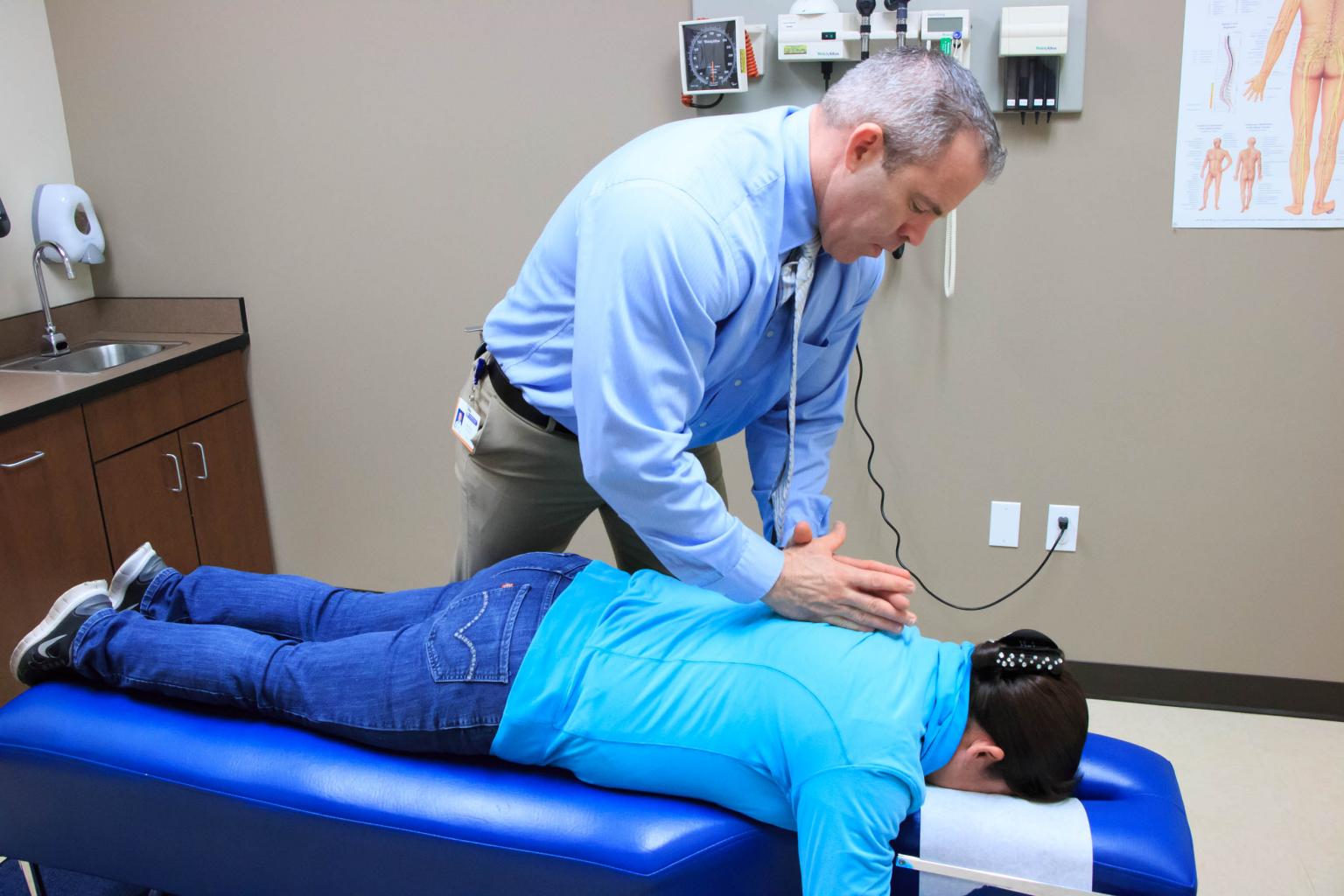 Chiropractor with patient on their front